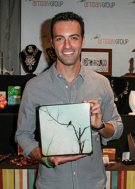 Reid Scott holds "In Branches, fine art photography print, red cardinal