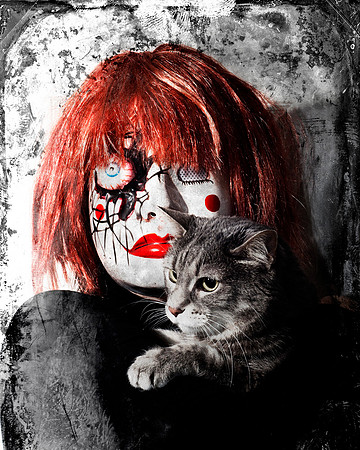 Halloween photograph of scary doll faced woman with grey cat