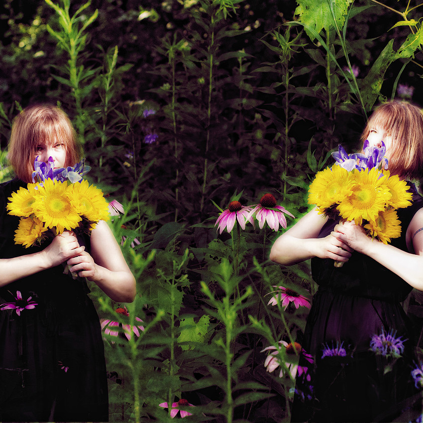 Photography composit portrait of twins with flowers in a giant garden.