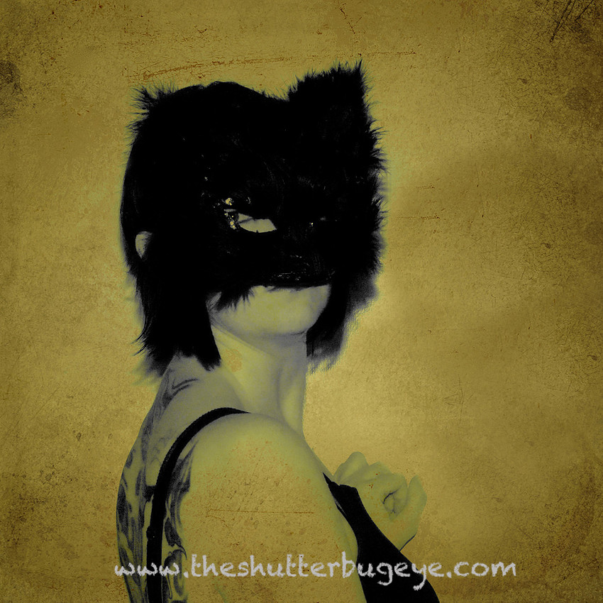 Masked self portrait, black cat