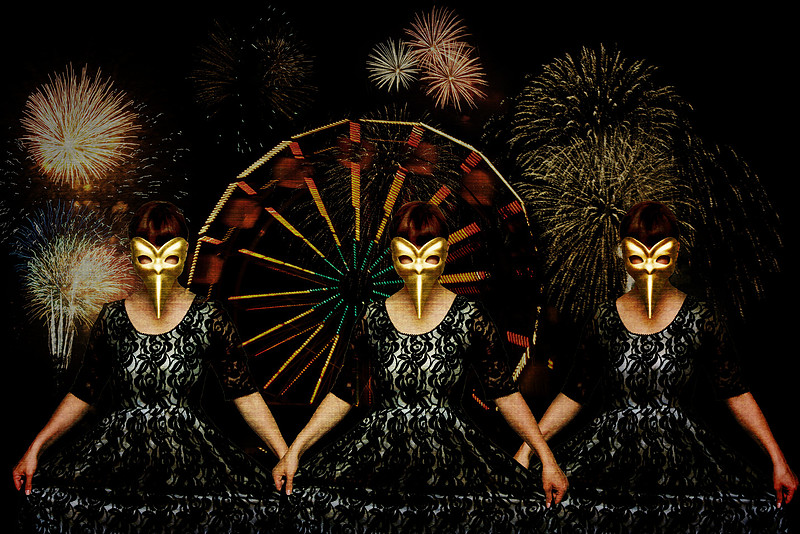 Masked women in front of fireworks and a carnival at night