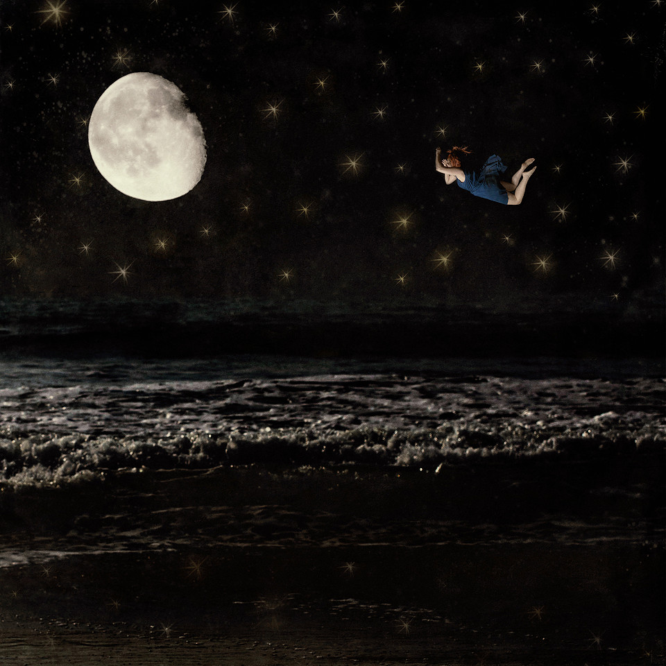 Photograph of a woman falling to the water under the light of the moon.