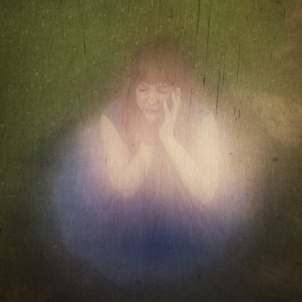 Painterly photograph of a woman in a blue dress.