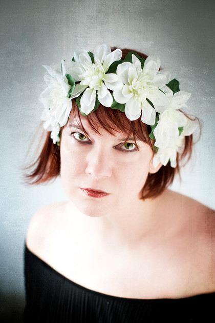 Portrait photograph of woman with a flower crown.