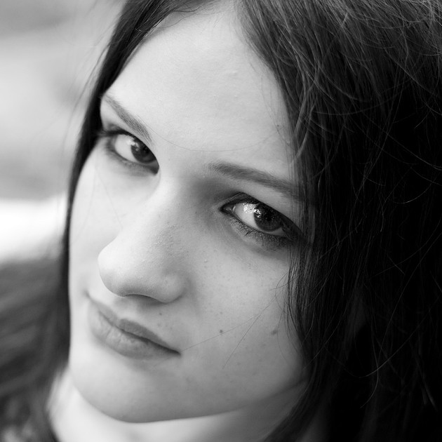 Close-up portrait photograph in black and white